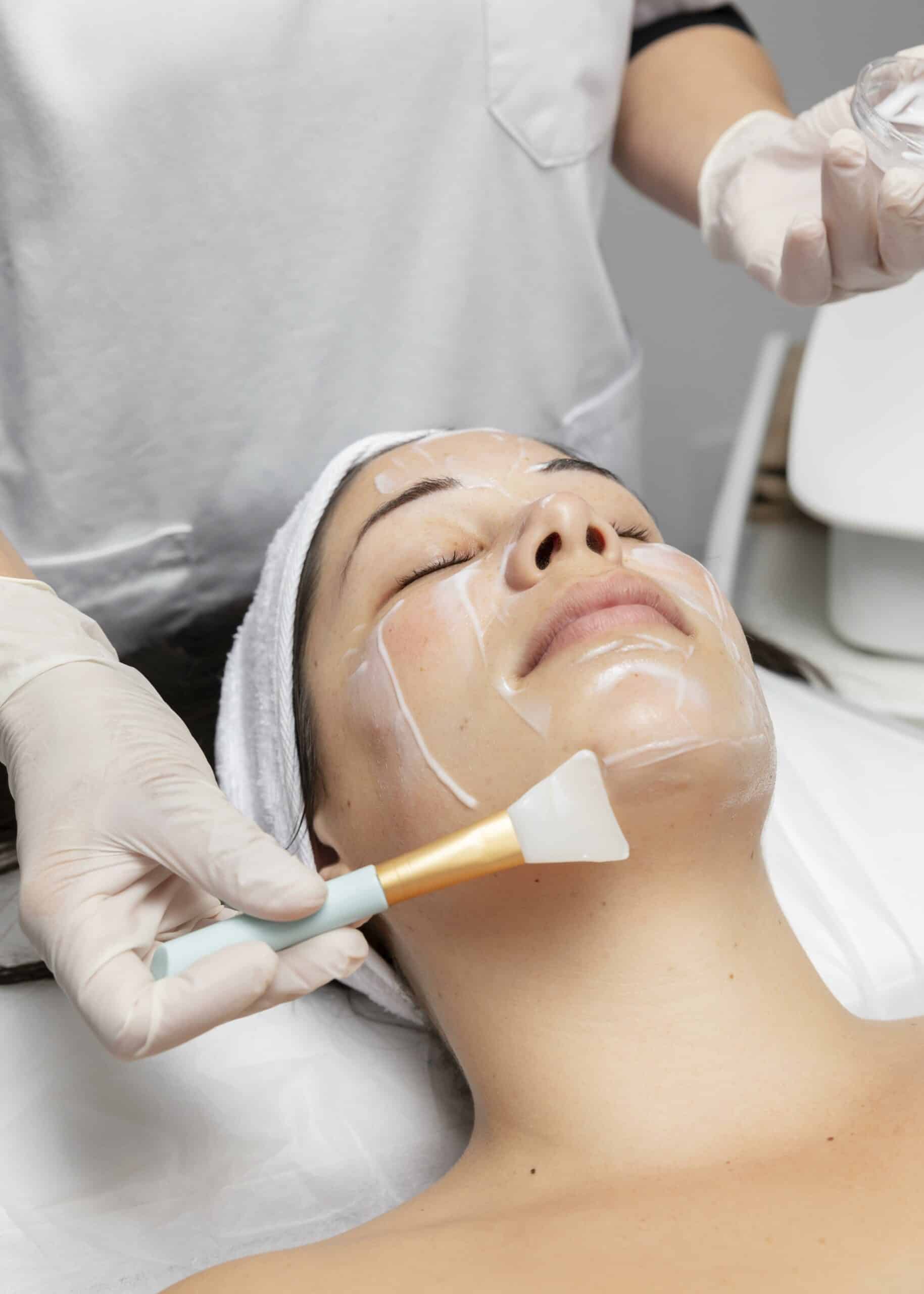 young-woman-having-facial-skincare-treatment-scaled